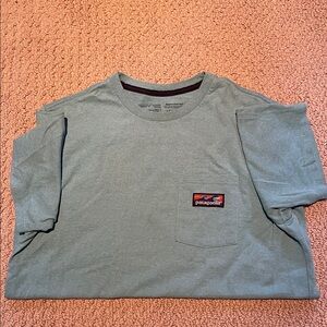 Patagonia Men’s Blue T-Shirt with pocket size small.